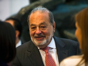 Mexican billionaire Carlos Slim greets attendees before speaking about a new educational application during a news conference at the Museo Soumaya in Mexico City, Wednesday, June 15, 2016. The application, titled Aprende, is free and is currently in use. (AP Photo/Nick Wagner)