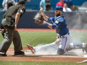 Jays catcher Russell Martin is out after hurting his knee after slipping in the sauna. (CANADIAN PRESS)