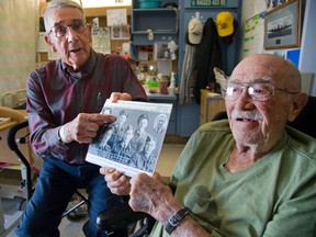 John (Chic) Neill, left, and Lorne Spicer, who flew bombing missions together with No.426 (Thunderbird) Squadron RCAF during the Second World War, are now both residents at London?s Parkwood Hospital. They?re holding a group portrait taken at their old Bomber Command base at Linton-On-Ouse, Yorkshire. (Mike Hensen/The London Free Press)