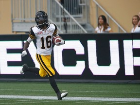 Hamilton Tiger-Cats' Brandon Banks (16) runs in the punt return for the touchdown against the Winnipeg Blue Bombers during the first half of CFL action in Winnipeg Thursday, July 2, 2015.