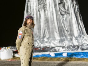 In this Monday, July 11, 2016 photo released Wednesday, July 20, 2016 by Morton, Russian adventurer Fedor Konyukhov stands by his helium and hot-air balloon being inflated before liftoff on his record attempt to fly solo in a balloon around the world nonstop in Northam in Western Australia state. (Oscar Konyukhov/Morton via AP)