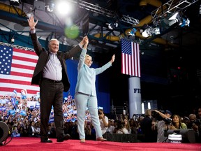 Democratic presidential candidate Hillary Clinton and Sen. Tim Kaine, D-Va., arrive at a rally at Florida International University Panther Arena in Miami, Saturday, July 23, 2016. Clinton has chosen Kaine to be her running mate. (AP Photo/Andrew Harnik)