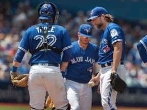 Blue Jays starting pitcher R.A. Dickey waits on the mound for manager John Gibbons in the fourth inning against the Mariners during MLB action in Toronto on Saturday, July 23, 2016. (Fred Thornhill/The Canadian Press)