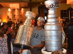Pittsburgh Penguins defenseman Trevor Daley holds the Stanley Cup next to his Stanley Cup cake at Spice Route on King St. W. on Saturday (Aaron D'Andrea/Toronto Sun/Postmedia Network)