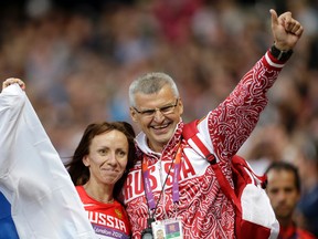 Russia's Mariya Savinova poses with her coach Vladimir Kazarin after her win in the women's 800-metre final at the 2012 Summer Olympics in London on Aug. 11, 2012. Russia will find out on Sunday if the IOC will exclude the country entirely following allegations of state-sponsored doping and cover-ups from next month's games in Rio de Janeiro. (Lee Jin-man/AP Photo/Files)