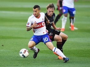 Toronto FC’s Sebastian Giovinco moves the ball past D.C. United’s Jared Jeffrey during last night’s game at BMO Field. (THE CANADIAN PRESS)
