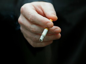 A man smokes a cigarette in Sydney's central business district, May 31, 2010. GREG WOOD/AFP/Getty Images