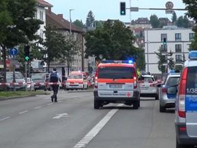 In this grab taken from video, police officers secure the area after a machete attack in Reutilingen, Germany, Sunday, July 24, 2016. A Syrian man killed a woman with a machete and wounded two others Sunday outside a bus station in the southwestern German city of Reutlingen before being arrested. Police said there were no indications pointing to terrorism. (NONSTOP NEWS via AP)