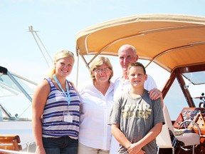 A proud family stands aboard the Black Beauty with its mirror-finish mahogany hull. The 1957 Chris-Craft was among the boats displayed during the annual Antique and Classic Boat Show Saturday at the Sarnia Bay Marina. Rick and Diane Laenen came to the the show from St. Clair, Mich. with grandchildren Emilee and Andrew. (Neil Bowen/Sarnia Observer)