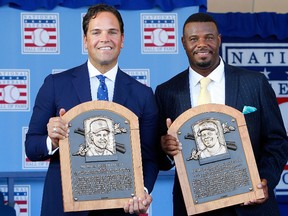 Mike Piazza and Ken Griffey Jr. pose with their plaques at Clark Sports Center after the Baseball Hall of Fame induction ceremony in Cooperstown, N.Y., on July 24, 2016. (Jim McIsaac/Getty Images)