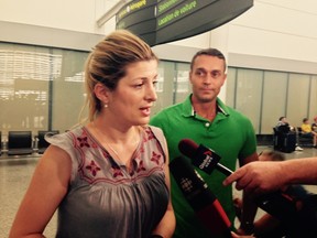 Air Canada passenger Nina Bullock recounts her delayed flight ordeal as Toronto boyfriend  Alex de Jonge listens after she arrived with her two children at Pearson airport Sunday, July 24, 2016. (Kevin Connor/Toronto Sun)