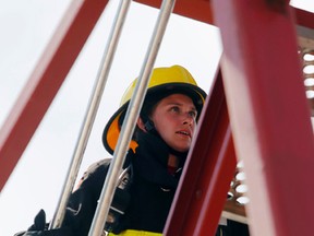 Volunteer firefighter Jocelyn Brethour charges up the tower stairs while competing in a relay race of the Belleville Firefit southern Ontario regional championship in Belleville Sunday. She's the Belleville Fire Department's first female Firefit athlete and it was her debut contest.
