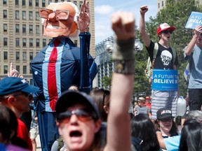 Supporters of Sen. Bernie Sanders, I-Vt., march during a protest in downtown on Sunday, July 24, 2016, in Philadelphia. The Democratic National Convention starts Monday in Philadelphia. (AP Photo/John Minchillo)