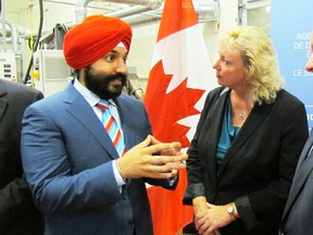 Navdeep Bains, federal minister of innovation, science and economic development, left, speaks with Sarnia-Lambton MP Marilyn Gladu and Sandy Marshall, executive director of Bioindustrial Innovation Canada (BIC), following the announcement of $12 million in funding for Sarnia-Lambton-based BIC on Monday July 25, 2016 in Sarnia, Ont. (Paul Morden/Sarnia Observer)