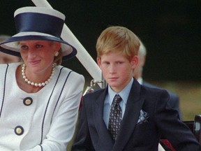 In this Aug. 19, 1995 file photo, Britain's Princess Diana, left, sits next to her younger son Prince Harry during V-J Day celebrations in London.  Britain's Prince Harry said in mid July 2016 that he wishes he had spoken sooner about the death of his mother, Princess Diana. Harry, who did not speak about his bereavement until three years ago, told the BBC that it wasn't a sign of weakness to speak about problems.  (AP Photo/Alastair Grant, file)