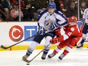 Sudbury Wolves defenceman Reagan O'Grady (7) and Soo Greyhounds centre Morgan Frost jockey for puck possession during first-period play Wednesday, Jan. 20, 2016 at Essar Centre in Sault Ste. Marie, Ont. JEFFREY OUGLER/POSTMEDIA NETWORK