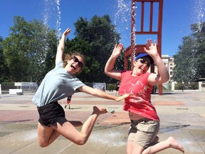 Exchange partners Gaëlle Revaclier, 14, and Elizabeth Cunnington, 15, from Ingersoll, jump outside the Broken Chair sculpture at the UN European Headquarters in Geneva during Cunnington's three-week exchange trip in July 2016. (Submitted)