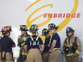 A stock photo of firefighters and Enbridge at the site of a gas leak.