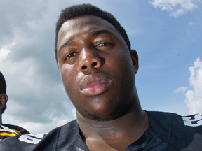 In this Aug. 8, 2013, file photo, Iowa defensive linemen Faith Ekakitie poses during the NCAA college football team's media day in Iowa City, Iowa. (AP Photo/Iowa City Press-Citizen, David Scrivner, File)