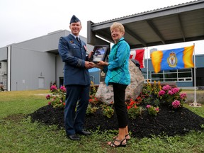 Emily Mountney-Lessard/The Intelligencer
Lt. Col. DJ Butcher, commanding officer of ATESS, is shown here with Sharyn Bachlet, the wife of John Paul Bachlet, former ATESS commanding officer, during a ceremony on Monday at CFB Trenton. The ATESS refinishing shop was named in honour of Bachlet and his contributions to 8 Wing and the RCAF.