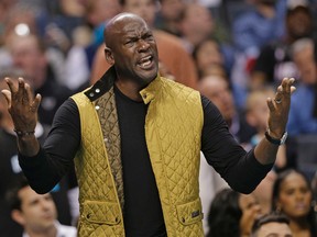 Charlotte Hornets owner Michael Jordan reacts to a call in the first half of an NBA basketball game against the Miami Heat in Charlotte, N.C., on Dec. 9, 2015. (AP Photo/Chuck Burton)
