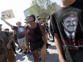 A Black Lives Matter protester shouts slogans next to next to a supporter of Republican presidential candidate Donald Trump, right, in Public Square on Tuesday, July 19, 2016, in Cleveland, during the second day of the Republican convention. (AP Photo/Mary Altaffer)