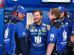 Dale Earnhardt Jr., second from left, chats with his crew in the garage during NASCAR Sprint Cup practice at Daytona International Speedway, Thursday, June 30, 2016, in Daytona Beach, Fla. (AP Photo/Wilfredo Lee)