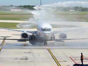 A New Leaf jet is sprayed with water as it arrives in Winnipeg, Man. Monday July 25, 2016. Brian Donogh/Winnipeg Sun/Postmedia Network