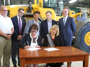 A major funding announcement took place in the RM of West St. Paul just north of Winnipeg, Man., on Monday, July 25, 2016. The federal government and the province reached an agreement under the new federal infrastructure funding programs. Pictured: Member of the Legislative Assembly of Manitoba for Agassiz and Minister of Indigenous and Municipal Relations Eileen Clarke signs the agreement as Member of Parliament for Kildonan-St. Paul and the Honourable MaryAnn Mihychuk, Minister of Employment, Workforce Development and Labour sits next to her. Back Row L-R: West St. Paul Mayor Bruce Henley, Member of Parliament for Charleswood—St. James—Assiniboia—Headingley Doug Eyolfson, Member of the Legislative Assembly of Manitoba for St. Paul Ron Schuler, Member of Parliament for Winnipeg South Terry Duguid, and Association of Manitoba Municipalities President Chris Goertzen. (Brook Jones/Selkirk Journal/Postmedia Network)