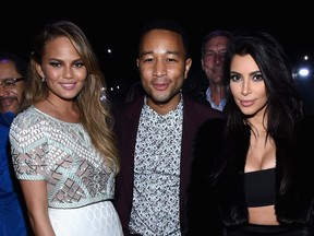Model Chrissy Teigen, recording artist John Legend and TV personality Kim Kardashian attend DirecTV Super Saturday Night hosted by Mark Cuban's AXS TV and Pro Football Hall of Famer Michael Strahan at Pendergast Family Farm on January 31, 2015 in Glendale, Arizona.  Mike Coppola/Getty Images for DirecTV/AFP