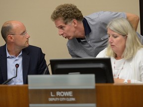 Mayor Matt Brown, Deputy Mayor Paul Hubert, and Deputy Clerk Linda Rowe confer during a debate on whether to elect a second deputy mayor to replace Maureen Cassidy at London city hall Monday. (MORRIS LAMONT, The London Free Press)