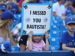 A young fan holds up a sign welcoming back Jose Bautista of the Toronto Blue Jays before the start of a game against the San Diego Padres on July 25, 2016 at Rogers Centre in Toronto. (Tom Szczerbowski/Getty Images)