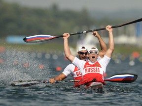 Russia's Yury Postrigay and Alexander Dyachenko celebrate after the men's kayak double (K2) 200m event at Eton Dorney during the London Olympics on August 11, 2012. (AFP PHOTO/PHILIP BROWN)