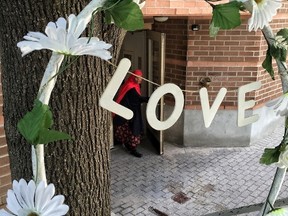 A small memorial of flowers sits outside 55 Hilda St., where Abdirahman Abdi suffered severe injuries while being arrested by Ottawa Police Sunday.