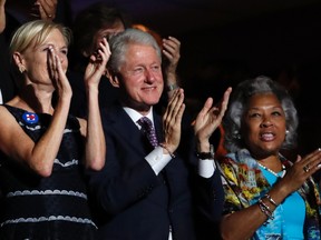 Former President Bill Clinton applauds Former Democratic Presidential candidate, Sen. Bernie Sanders, I-Vt., as he speaks during the first day of the Democratic National Convention in Philadelphia , Monday, July 25, 2016. (AP Photo/Paul Sancya)