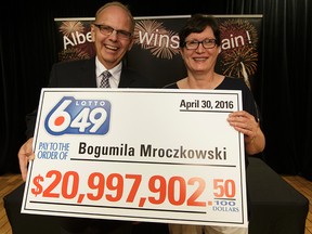 AGLC President Bill Robinson (left) presents a ceremonial cheque to Lotto 6/49 $21 million winner Bogumila Mroczkowski at the Alberta Gaming & Liquor Commission in St. Albert, on Tuesday, July 26, 2016. Ian Kucerak / Postmedia