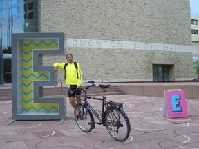 Peter Ledingham was riding his bike across Canada when the journey was stopped, at least temporarily, by theft of his bike in Regina. Ledingham is pictured here outside Edmonton City Hall. Submitted photo