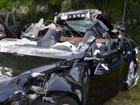 This photo provided by the NTSB via the Florida Highway Patrol shows the Tesla Model S that was being driven by Joshau Brown, who was killed, when the Tesla sedan crashed while in self-driving mode on May 7, 2016. The National Transportation Safety Board said in a preliminary report on July 26 that the Tesla Model S was traveling at 74 mph in a 65-mph zone on a divided highway in Williston, Fla., near Gainesville, just before hitting the side of a tractor-trailer. (NTSB via Florida Highway Patrol via AP)