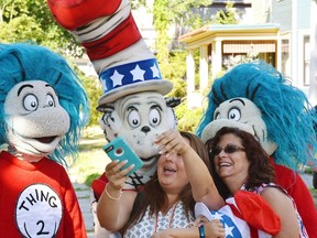A character portraying the Cat in the Hat poses for a selfie with supporters Tuesday, July 26, 2016, after he announced he is running for President with running mates Thing 1 and Thing 2 outside the childhood home of their creator Theodor Geisel, better known as Dr. Seuss, on Fairfield Street in Springfield, Mass. The event served as the official launch for the new Random House book "One Vote, Two Votes, I Vote, You Vote." (Dave Roback/The Republican via AP)