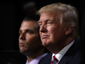 Donald Trump, right, is seen here with his son Donald Trump Jr. at the Republican National Convention in Cleveland on July 20, 2016. (AP Photo/Matt Rourke, File)