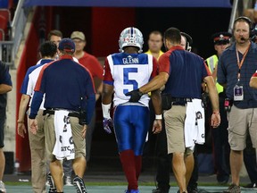 Alouettes quarterback Kevin Glenn is helped off the field against the Argonauts during CFL action at BMO Field in Toronto on Monday, July 25, 2016. (Dave Abel/Toronto Sun)