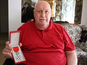 Second World War veteran Jack Western, 93, shows his Legion of Honour medal -- France's highest national award -- in his Sarnia home Tuesday. Western was awarded the honour for helping to liberate France during the war. (Barbara Simpson/Sarnia Observer/Postmedia Network)