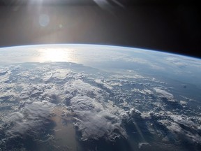 The sun's light reflects off Earth December 2, 2015. (NASA)