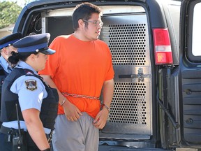 Nathan Koostachin is seen here in July 2016 being escorted inside the courts in Timmins for his first appearance. He pled guilty to manslaughter for the killing of 19-year-old Austin Thériault and was sentenced to 10 years.  LEN GILLIS/ Postmedia Network
