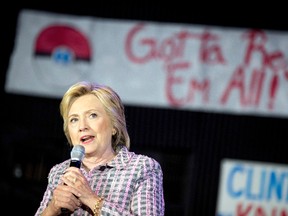 A Pokemon poster is visible behind Democratic presidential candidate Hillary Clinton as she speaks to volunteers at a Democratic party organizing event at the Neighborhood Theater in Charlotte, N.C., Monday, July 25, 2016. (AP Photo/Andrew Harnik)