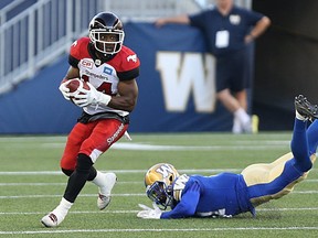 Winnipeg Blue Bombers DB Brendan Morgan misses a tackle on Calgary Stampeders RB Roy Finch during CFL action in Winnipeg on Thu., July 21, 2016.