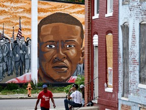 A mural depicting Freddie Gray is seen past blighted row homes in Baltimore, Thursday, June 23, 2016, at the intersection where Gray was arrested.  (AP Photo/Patrick Semansky)
