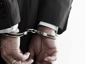 handcuffs businessman GETTY