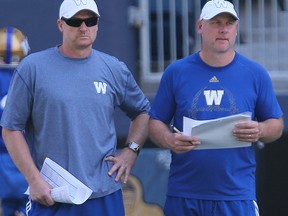 Winnipeg Blue Bombers head coach Mike O'Shea (left) and offensive coordinator Paul LaPolice watch play during practice on Tuesday. (Brian Donogh/Winnipeg Sun)