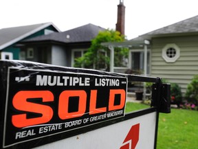Real estate signs adorn houses and condos sold and for sale in Vancouver in this  August 8, 2012 file photo.  (Gerry Kahrmann/Postmedia Network files)